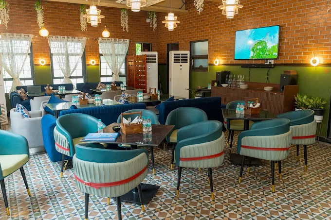The dining room, teal banquettes on patterned tile