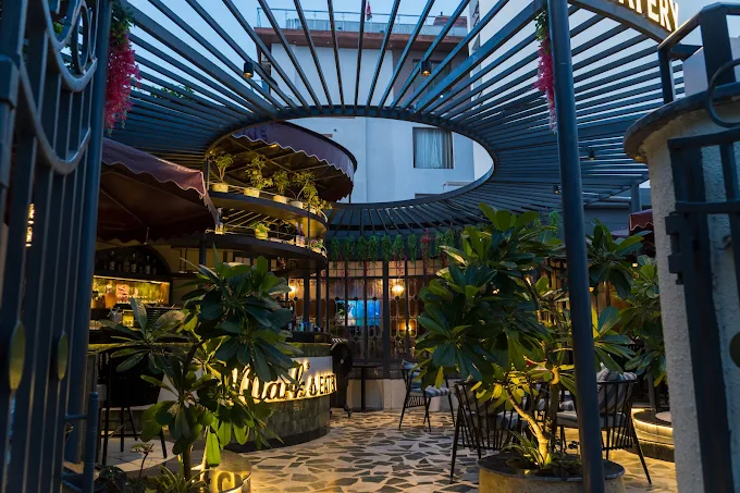 The courtyard in daylight, looking up through the steel pergola