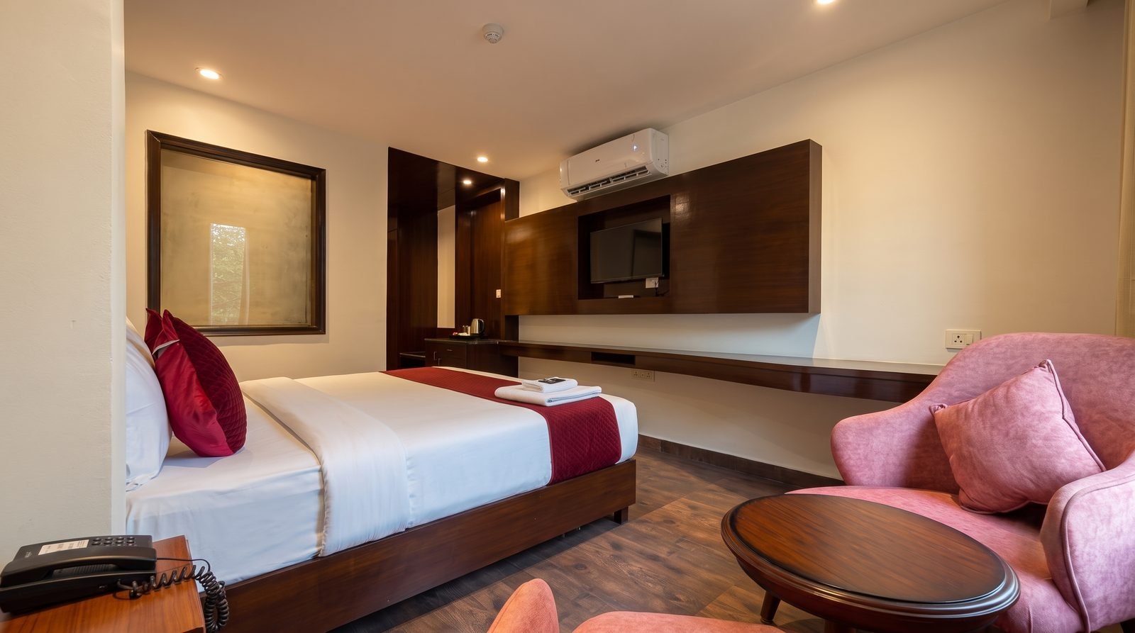 A guest room with a work desk set against the window