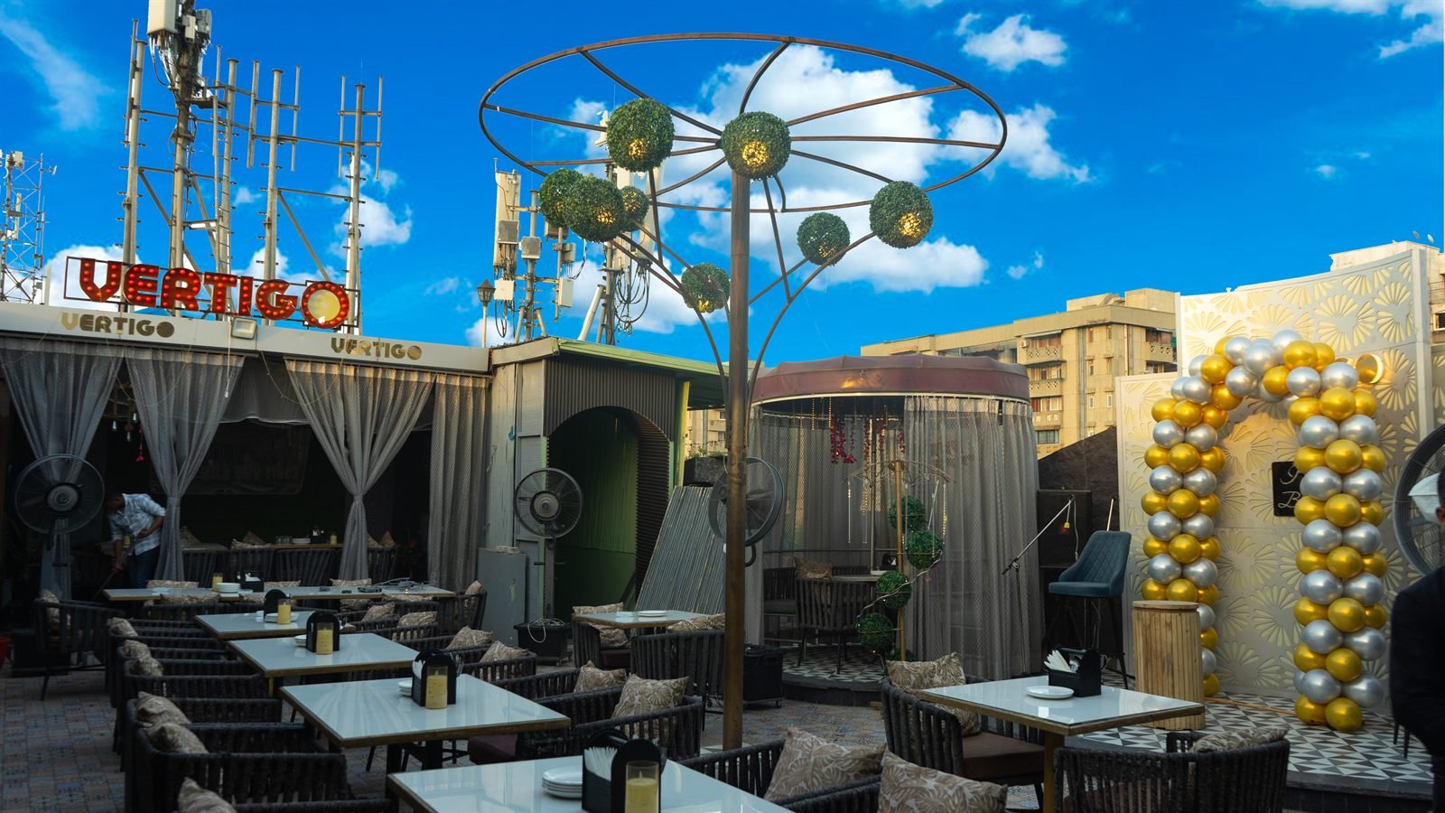 The Vertigo rooftop terrace, tables beneath open sky