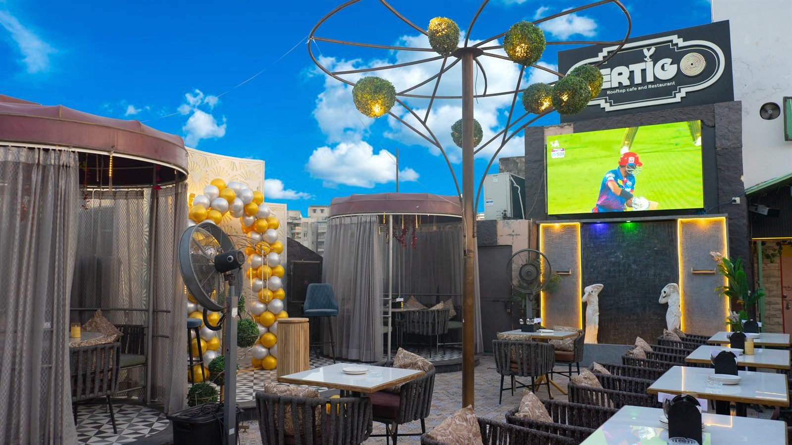 The rooftop in daylight, tables laid for the cafe hours